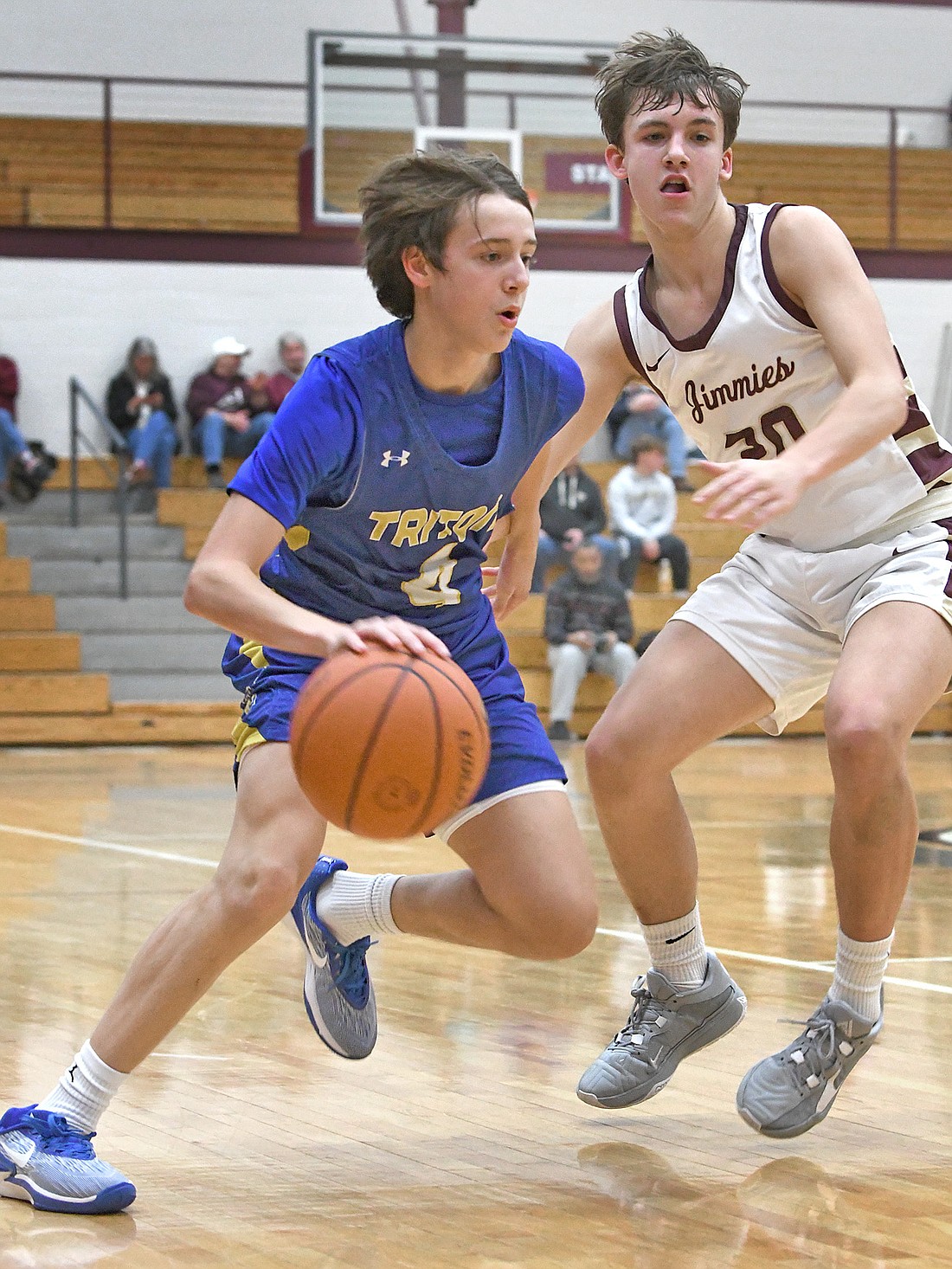 Sophomore Landon Patrick of Triton brings the ball into the forecourt as Jimtown's Will Spurgeon defends. Photo by Gary Nieter