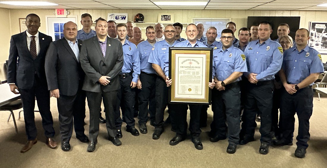 Warsaw Professional Fire Fighters Union Local 5461 receives its charter from Tony Murray, president, Professional Fire Fighters Union of Indiana, on behalf of International Association of Fire Fighters. Photo by David Slone, TIMES-UNION