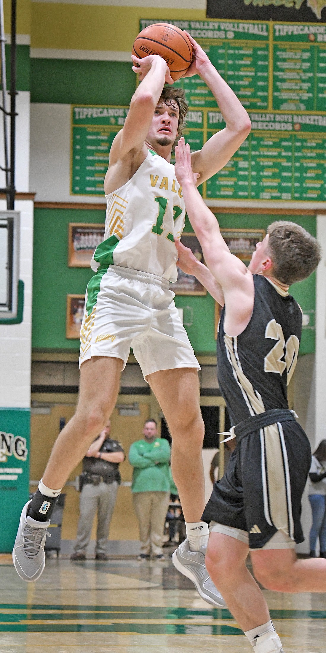 Playing his first game of the season due to injury, Tippecanoe Vallley senior Riley Shepherd shoots from long distance over Rochester's Owen Prater during the second quarter. Photo by Gary Nieter