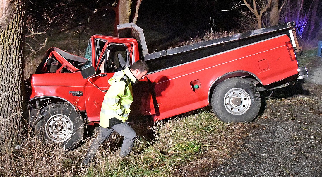 Kosciusko County Coroner Tyler Huffer investigates the scene of Thursday night's single-vehicle fatal accident on CR 200 N, east of CR 650 E. Photo by Gary Nieter, TIMES-UNION