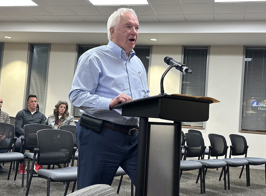 Attorney Steve Snyder (standing) makes his case before the Warsaw Board of Zoning Appeals on Wednesday regarding the petitions for 4 Yarnelle Point, owned by Toby and Annelise Galloway (sitting).  Photo by David Slone, Times-Union