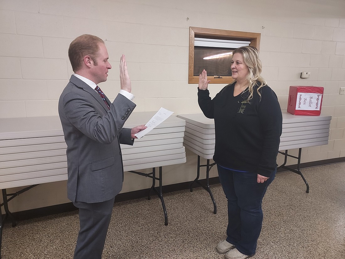 Kosciusko County Republican Central Committee Secretary Austin Rovenstine swears in Stephanie Stutzman into the Clay Township trustee position Wednesday. Photo by Jackie Gorski, Times-Union