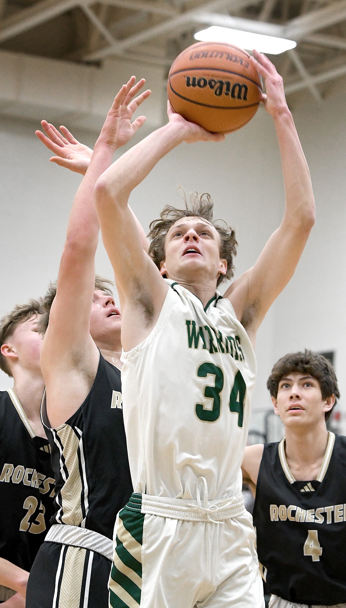 Junior Maddux Everingham of Wawasee scores two of his points while working under the basket during the first quarter. Photo by Gary Nieter