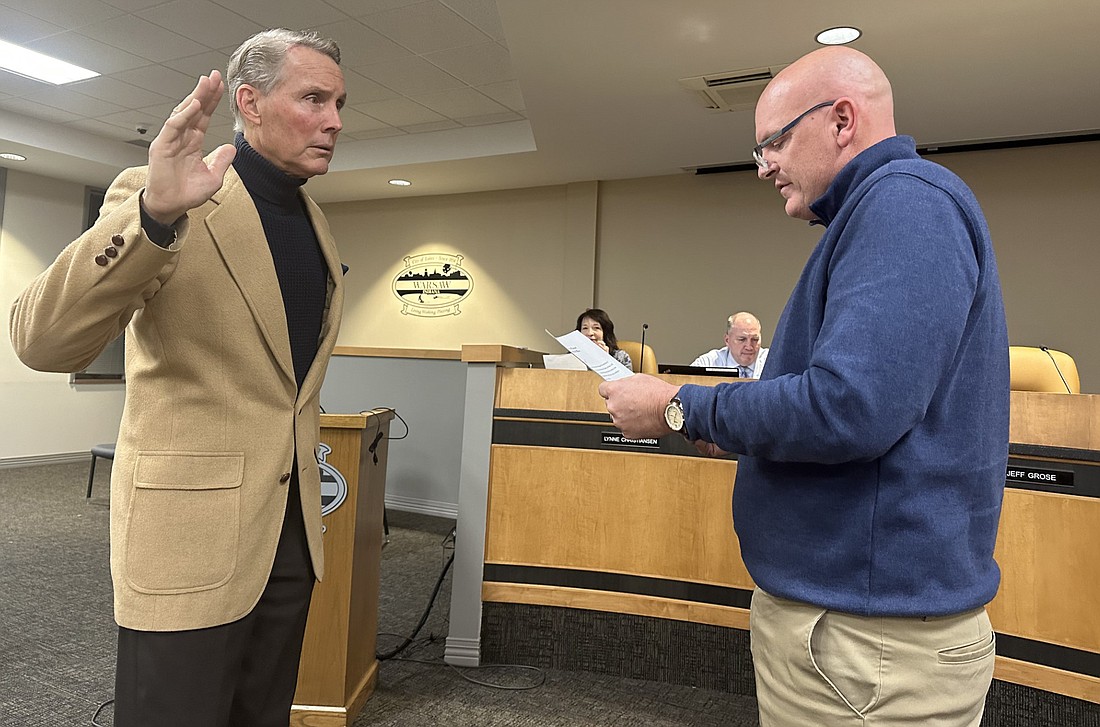 Warsaw Mayor Jeff Grose (R) gives the oath of office Tuesday to Rick Keeven (L) for the Warsaw Board of Zoning Appeals. Photo by David Slone, Times-Union