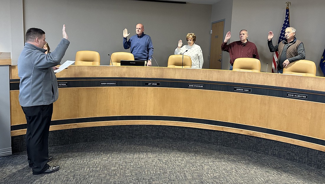 Warsaw-Wayne Fire Territory attorney Andrew Grossnickle (L) gives the oath of office to WWFT Board members (L to R) Mayor Jeff Grose, Wayne Township Trustee Jeanie Stackhouse, Gordon Nash and Warsaw Common Councilman Mike Klondaris on Tuesday. Photo by David Slone, Times-Union