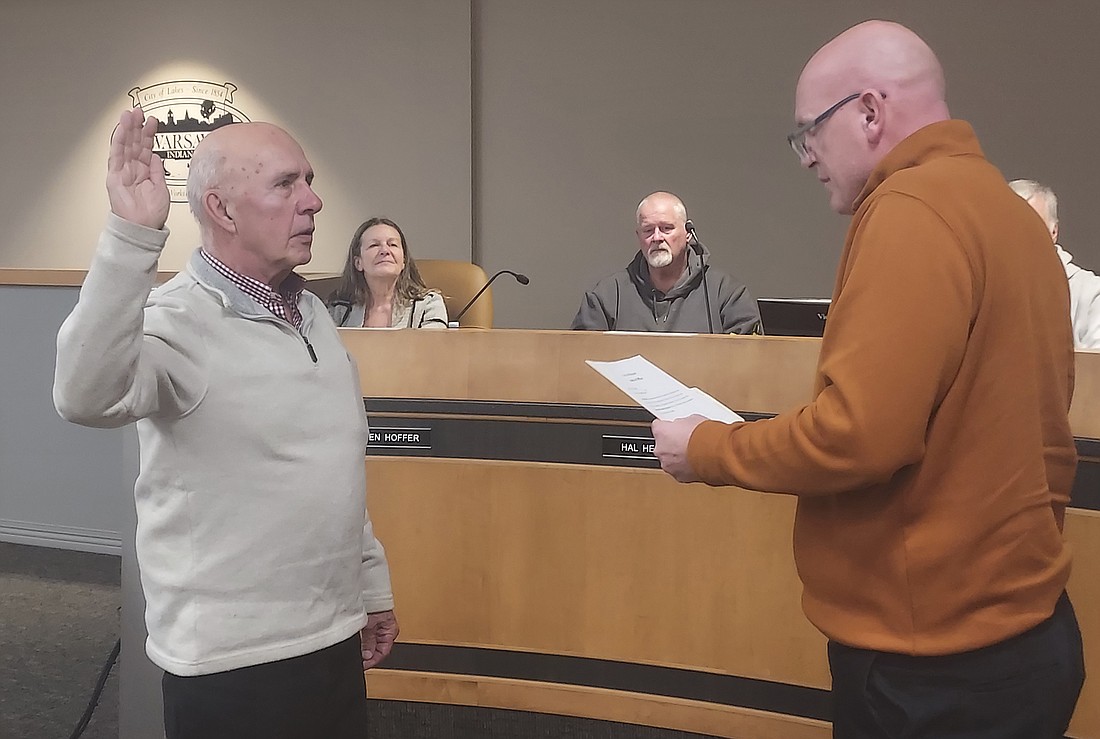 Warsaw Mayor Jeff Grose (R) swears in Max Mock to the Oakwood Board of Regents Thursday. Photo by Jackie Gorski, Times-Union