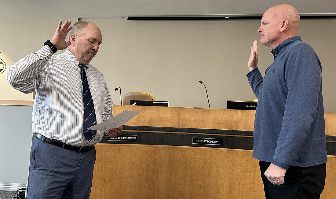 Warsaw city attorney Scott Reust (L) gives Mayor Jeff Grose the oath of office Friday for the Board of Public Works and Safety. Photo by David Slone, Times-Union