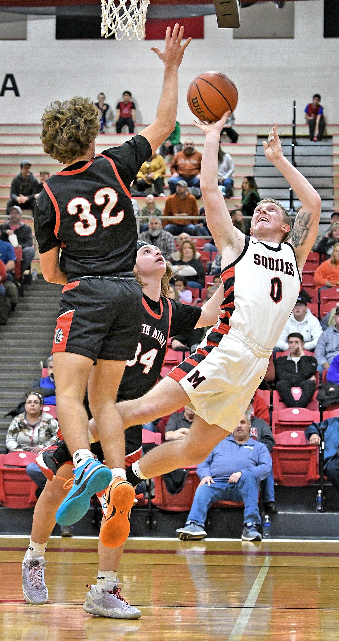 Manchester senior Garrett Sites puts up an acrobatic shot during Friday night's home game against North Miami. Photo by Gary Nieter