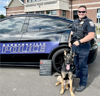 Bargersville Police Chief Todd Bertram stands alongside a K-9 and a Tesla recently fitted as a K-9 unit. Photo Provided