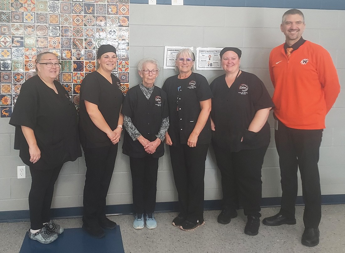 Monva Jean Lursen (third from left) poses with the cafeteria staff at Leesburg Elementary School and Principal Nathan Polston. Photo by Jackie Gorski, Times-Union