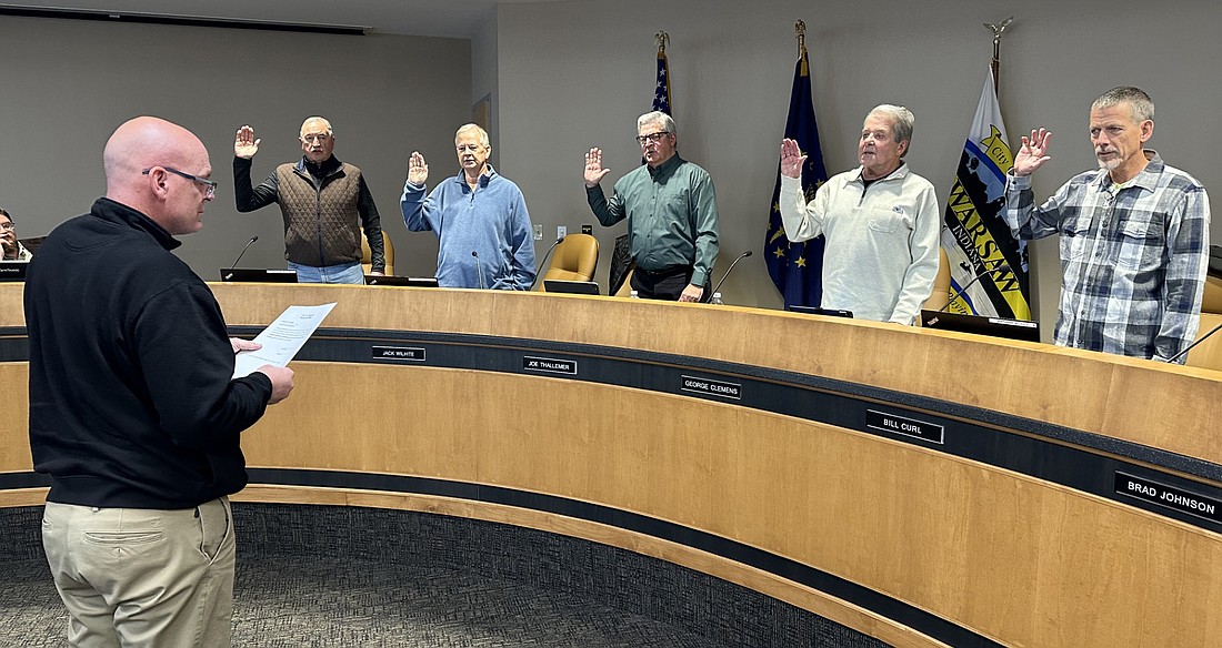 Warsaw Mayor Jeff Grose (L) gives the oath of office to Warsaw Redevelopment Commission members (L to R) Mike Klondaris, Jack Wilhite, Joe Thallemer, George Clemens and Bill Curl. For 2024, Clemens will serve as board president, Klondaris vice president and Curl as secretary. Photo by David Slone, Times-Union