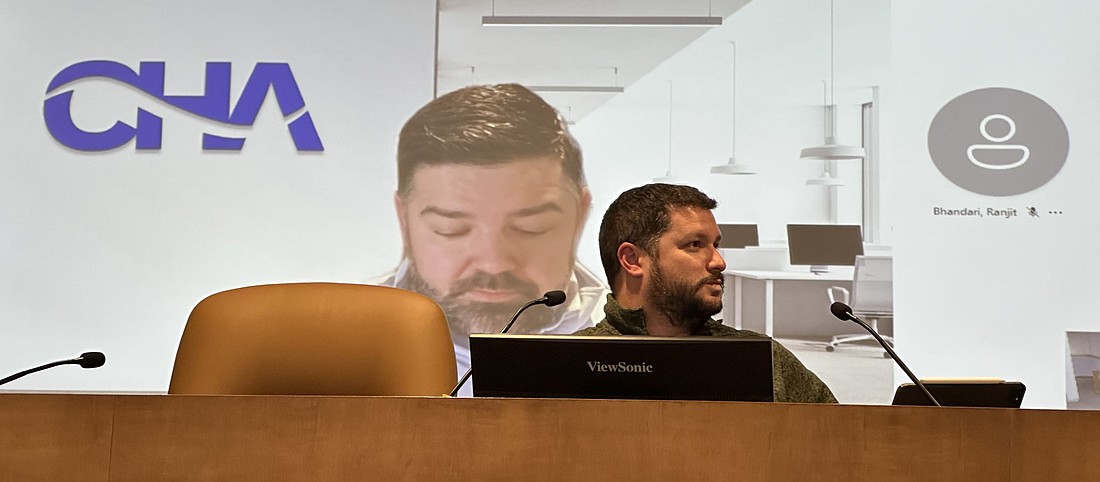 Warsaw Airport Manager Nick King talks to the Warsaw Board of Aviation Commissioners Tuesday about the instrument landing system (ILS), with Robert LaFayette looming on the big screen behind him. Photo by David Slone, Times-Union