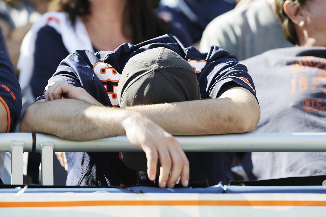 A Chicago Bears fan puts his head down during the second half of an NFL football game between the Bears and Green Bay Packers Sunday, Sept. 28, 2014, in Chicago. The Packers won 38-17. (AP Photo/Nam Y. Huh)