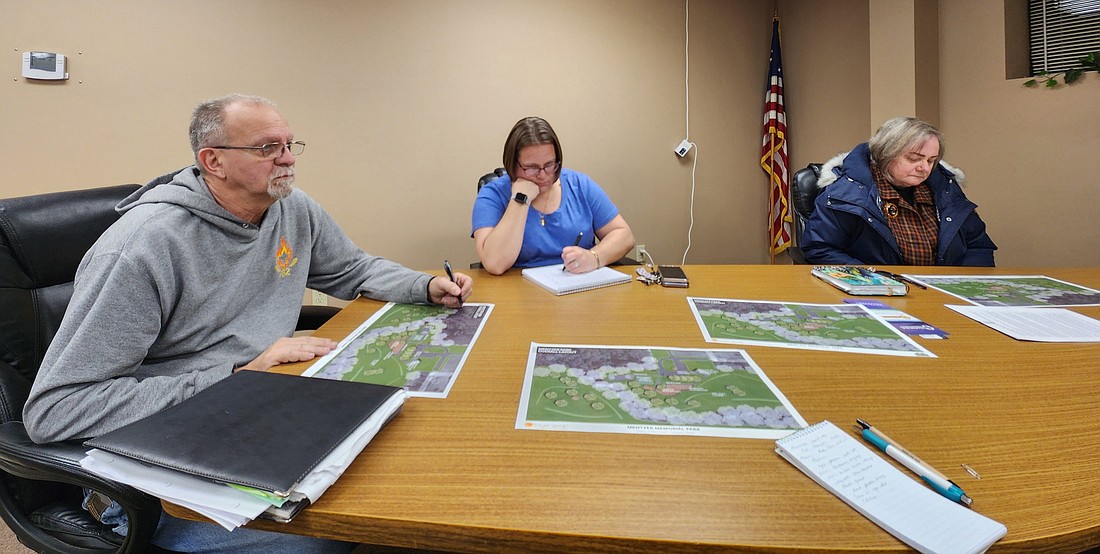 (L to R) Mentone Town Councilman Tim Croy, Clerk-Treasurer Amanda Yaprak and Councilwoman Shelly Krueger review the preliminary drawings for Mentzer Park improvements. Photo by Deb Patterson, InkFreeNews