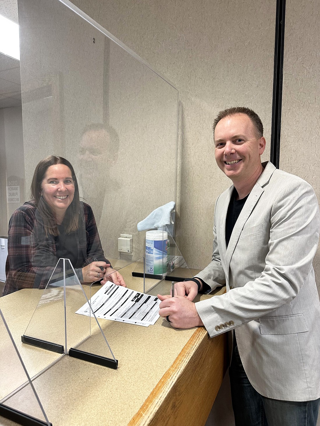 Republican Nathan Scherer (R) files Friday to run for northern district county commissioner. Assisting him with the paperwork is County Clerk Chief Deputy Melissa Boggs (L). Photo by David Slone, Times-Union