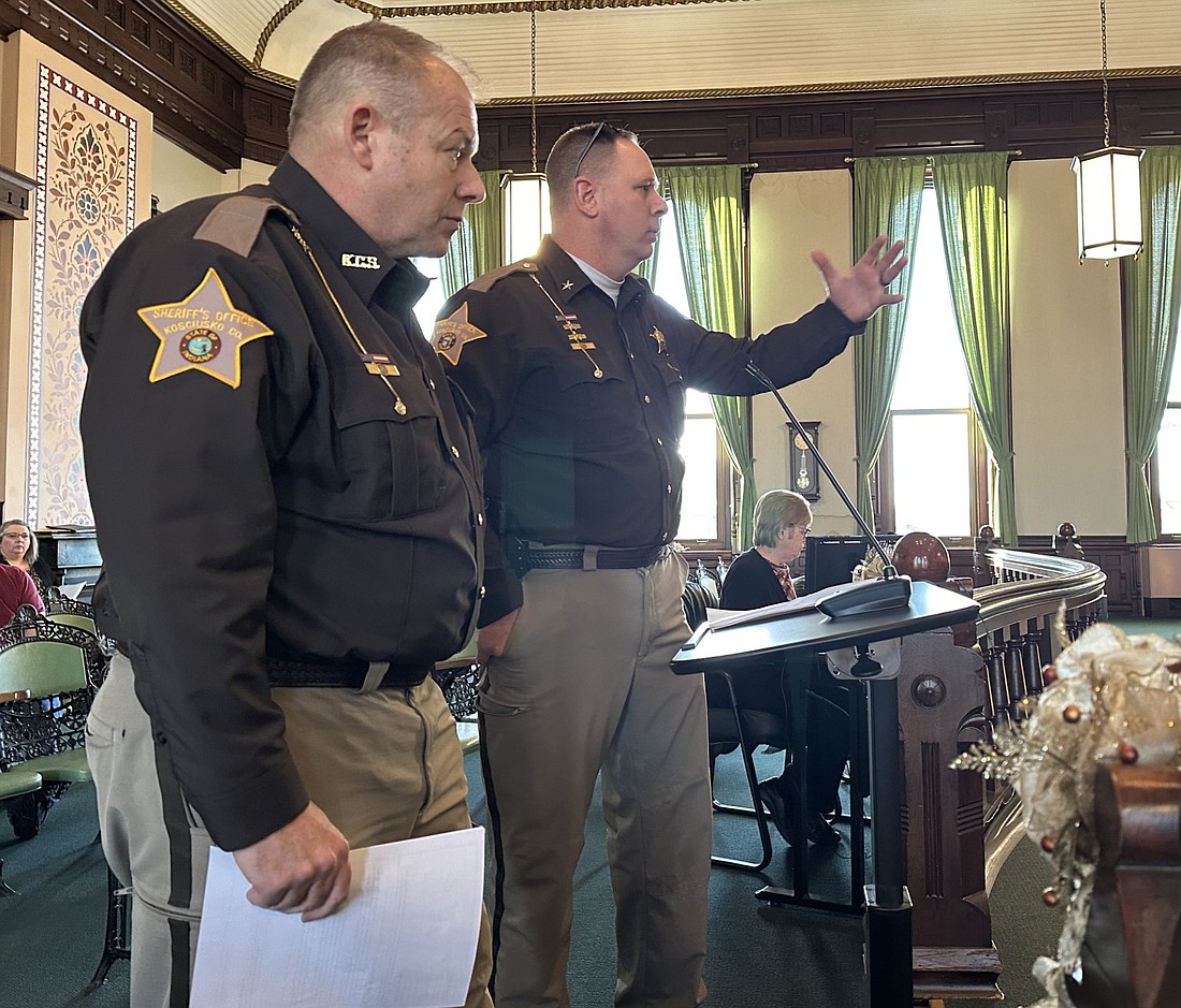 Kosciusko County Sheriff Jim Smith (R) and Chief Deputy Chris McKeand (L) present the grant applications for the County Recovery Program to the county commissioners Tuesday. Photo by David Slone, Times-Union