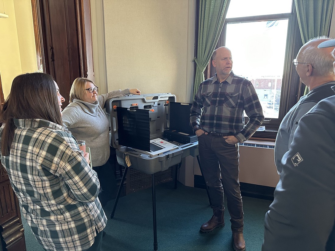 Checking out the voting equipment Tuesday at the Kosciusko County Commissioners meeting are (L to R) Melissa Boggs, county clerk’s office chief deputy; Ann Torpy, county clerk; Cary Groninger, county commissioners; Mike Kissinger, county surveyor; and Mike Long, county council president. Photo by David Slone, Times-Union