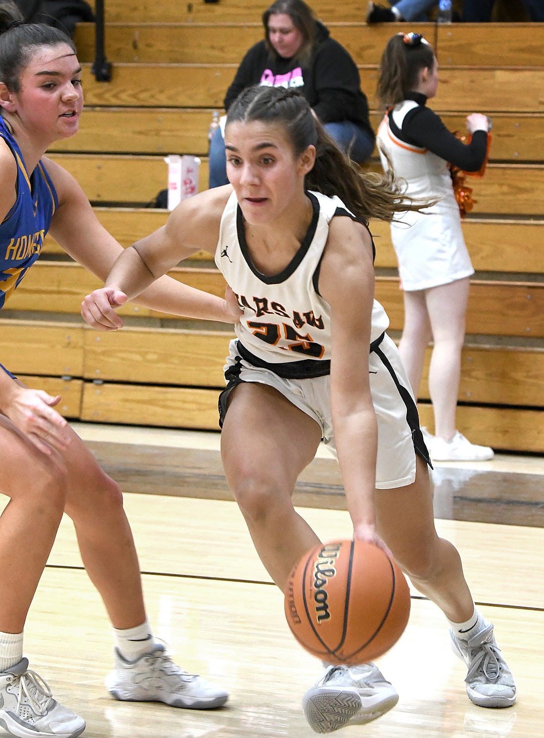 Warsaw junior Braylie Chastain dribbles along the baseline during the third quarter of Tuesday night's home game against Homestead. Photo by Gary Nieter