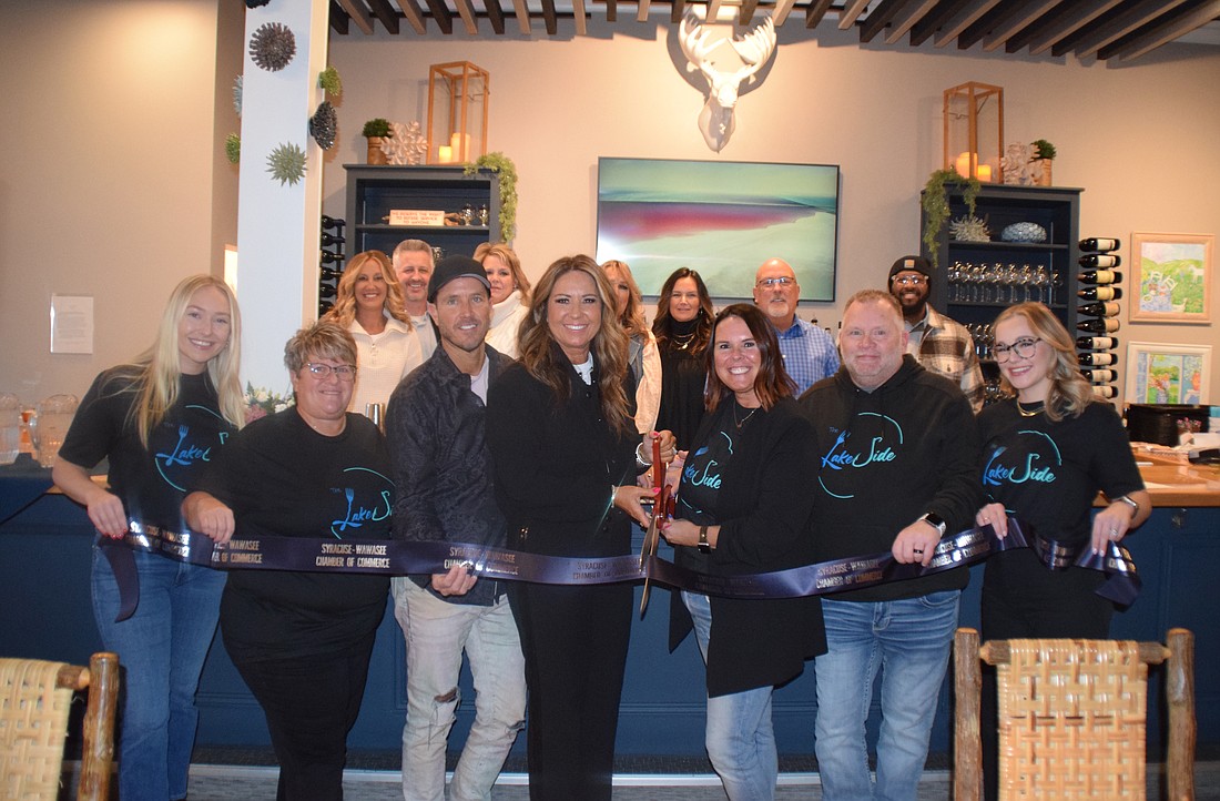 Shown participating in the ribbon-cutting at The Lakeside in Syracuse are (L to R), front row: Molly Liston, Shelly Sanders, Tad Gongwer, Corina Gongwer, Cassy Griffin, Tom Griffin, Ashley Griffin; back row: Ashley Dillon, Jeff Dyson, Rita Davis, Carla Fawley, Rachell Hatfield, Scott Wiley and Shawn Brown. Photo by Lauren Zeugner, InkFreeNews