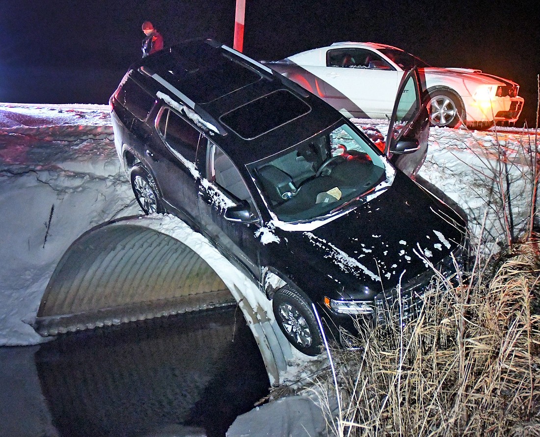 A vehicle came to rest in a very precarious position after Saturday's early morning single-vehicle accident on CR 175N, east of CR 175E. Photo by Gary Nieter, Times-Union