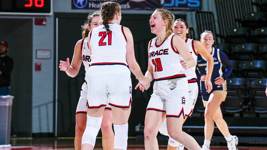 A group of Grace players celebrate after a big play.