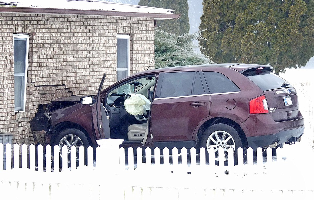 A single-vehicle accident Tuesday afternoon resulted in a southbound car veering off Ind. 15, north of CR 450N, going through a fence and into a house. Photo by Gary Nieter, Times-Union