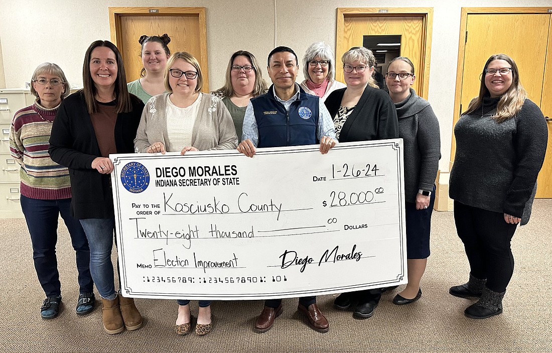 Indiana Secretary of State Diego Morales (front row, R) presents a Federal Help America Vote Act grant check for $28,000 to Clerk of the Circuit Court Ann Torpy (front, L) and her staff Friday. Photo by David Slone, Times-Union