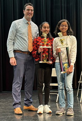 Principal Matt Deeds is pictured with runner-up Dhanishka Sudarsan and 2024 champion Chaitrali Chavan. Photo Provided.