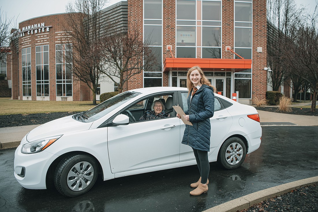 Janice Koontz, a 1959 Grace graduate and Warsaw resident, pulls up to the Manahan Orthopedic Capital Center where Grace College senior Alexis Bergman collects her tax documents for VITA. Photo Provided