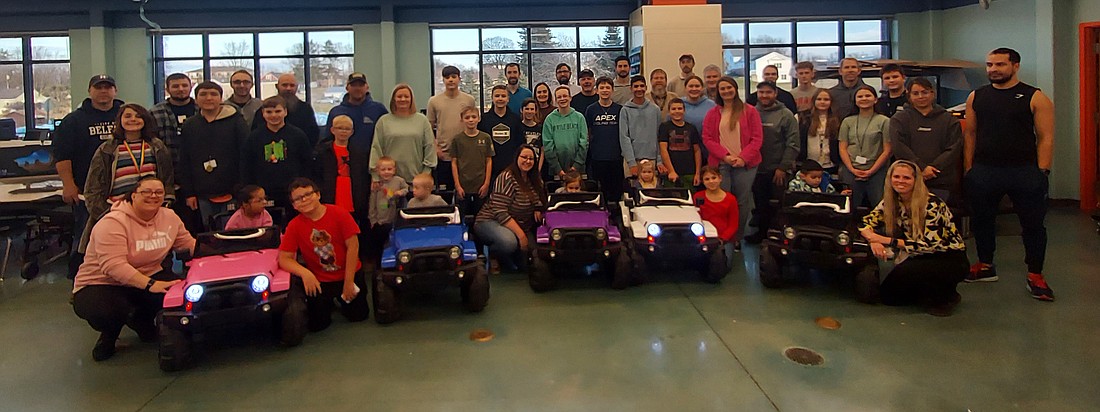 Pictured are the five toddlers who will have a Jeep modified for them in the GoBabyGo! program, as well as their families and the Edgewood Middle School students and mentors who will be working on the Jeeps. Photo by Jackie Gorski, Times-Union