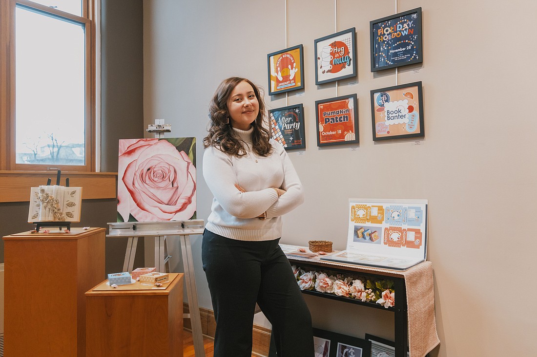 Joy Antonini showcases her thesis portfolio in the Mount Memorial Art Gallery at Grace College. Photo Provided.