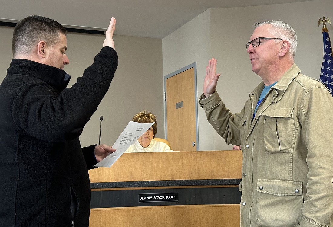 Warsaw-Wayne Fire Territory attorney Andrew Grossnickle (L) gives David Allbritten the oath of office for the WWFT Board Tuesday. Photo by David Slone, Times-Union