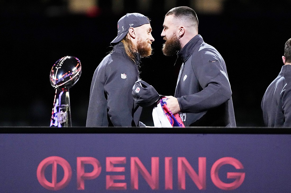 San Francisco 49ers tight end George Kittle and Kansas City Chiefs tight end Travis Kelce shake hands during NFL football Super Bowl 58 opening night Monday, Feb. 5, 2024, in Las Vegas. The San Francisco 49ers face the Kansas City Chiefs in Super Bowl 58 on Sunday. (AP Photo/Matt York)