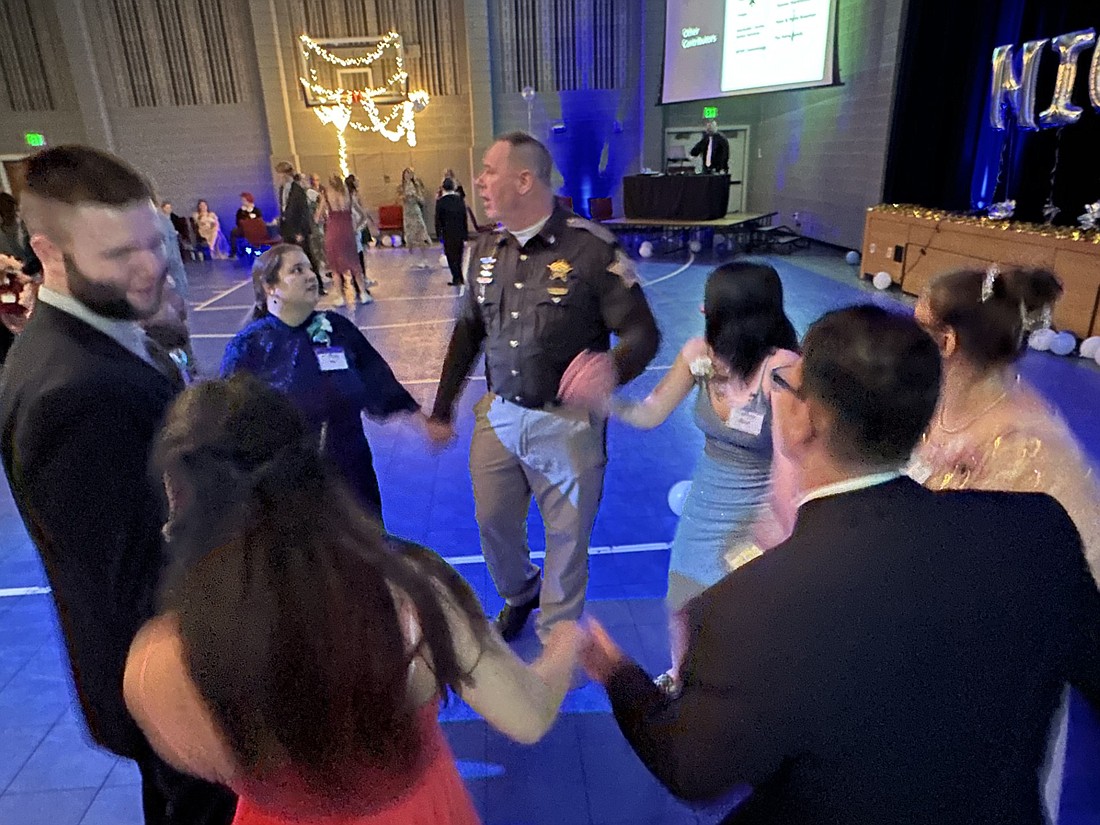 Kosciusko County Sheriff Jim Smith (C) dances with guests and buddies at the “Night to Shine” prom Friday in the gymnasium at Warsaw Evangelical Presbyterian Church. Photo by David Slone, Times-Union