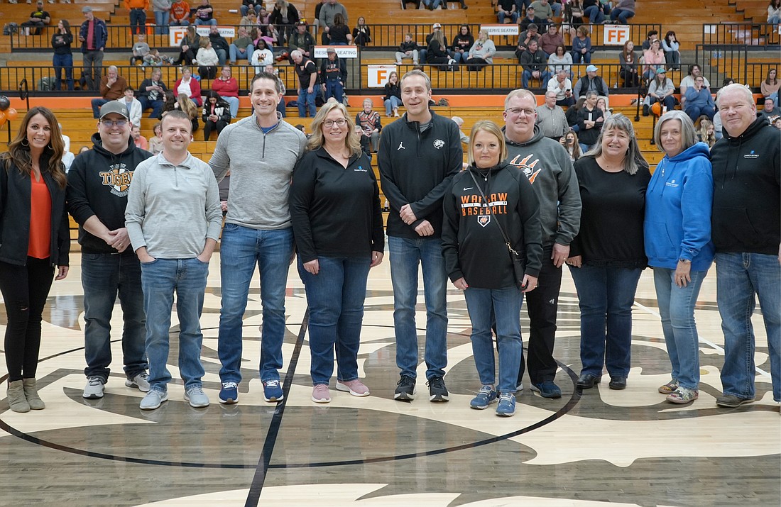 Warsaw Community Schools administrators Dr. David Hoffert and Krista Polston gathered with WCS board member Matt Deuel to recognize Adam Griner, Tabatha Mcdonald and other members of the Zimmer Biomet team at a recent home basketball game. Photo Provided.