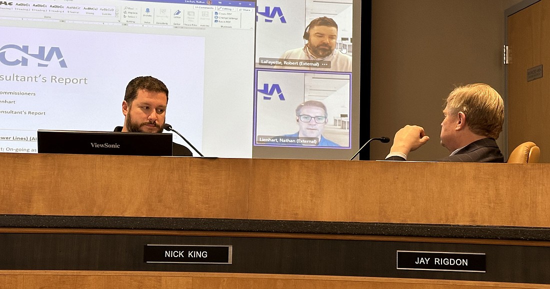 Warsaw Board of Aviation Commissioners President Jay Rigdon (R) and Airport Manager Nick King (L) listen to comments from Nathan Lienhart (bottom of screen), CHA Consulting aviation project manager, and Robert LaFayette (top of screen), CHA section manager aviation planning, during the board’s meeting Tuesday. Photo by David Slone, Times-Union