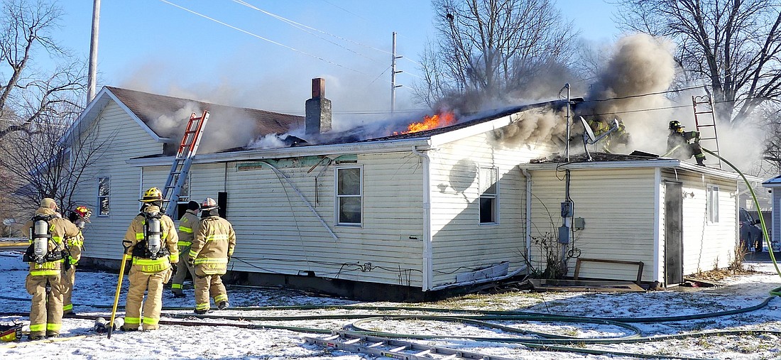 Firefighters have their hands full gaining control of Sunday morning's house fire on West Center Street in Warsaw. Photo by Gary Nieter, Times-Union