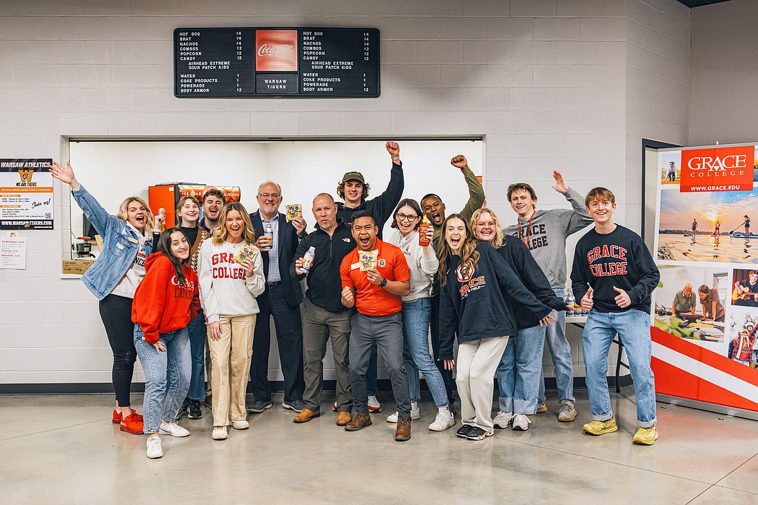 Grace College representatives and Warsaw Community High School Principal Troy Akers prepare to welcome students to the first ramen day event. Photo Provided.