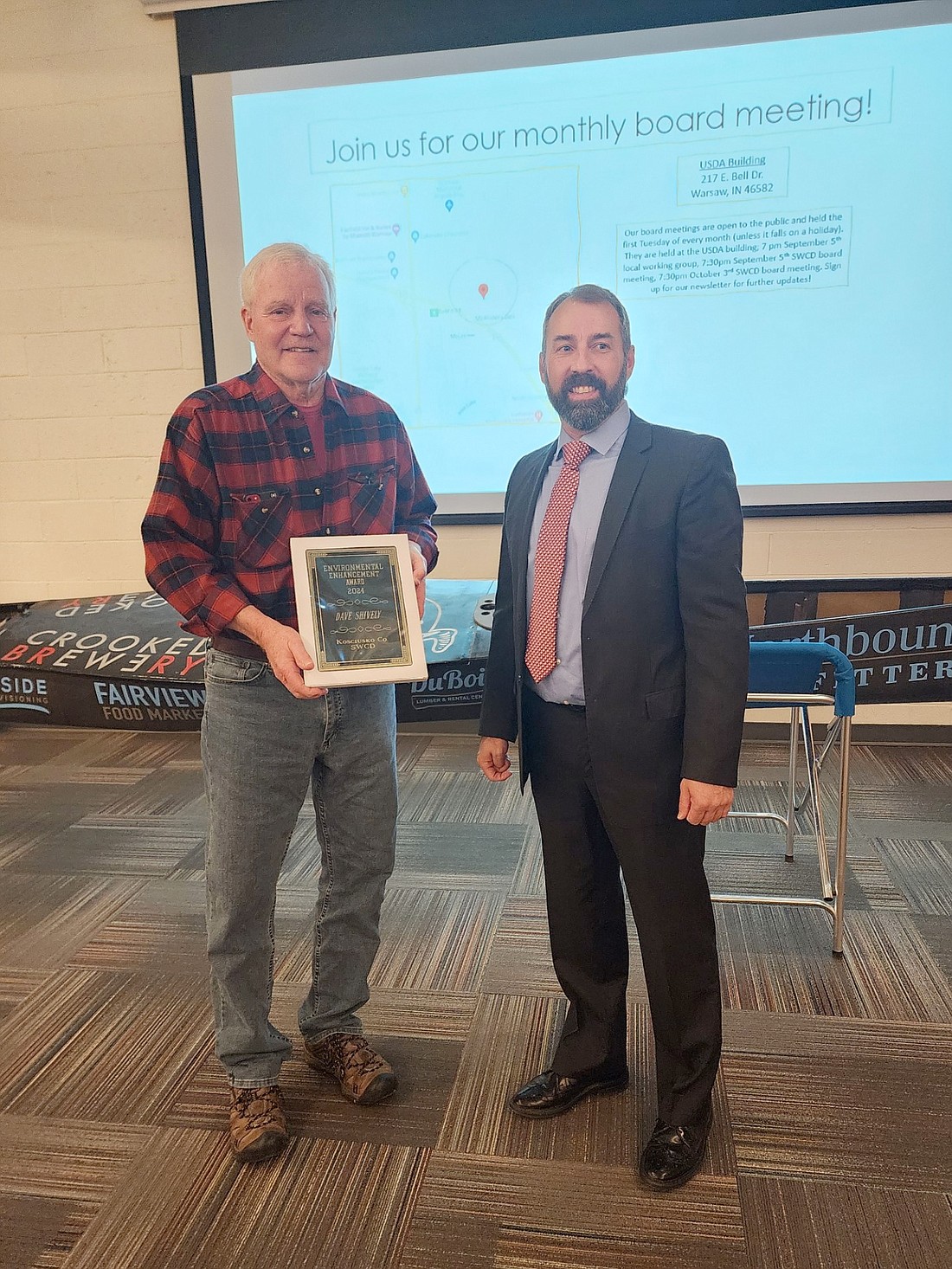 Dave Shivley (L) was presented the Environmental Enhancement Award, by Jamie Scott, Kosciusko SWCD vice chairman at the 67th annual Kosciusko Soil and Water Conservation District’s annual meeting Tuesday. Photo by Deb Patterson, InkFreeNews