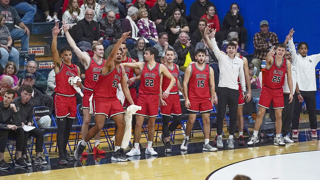 Pictured is Grace's bench celebrating a first-half 3-pointer during the Lancers' rout of St. Francis