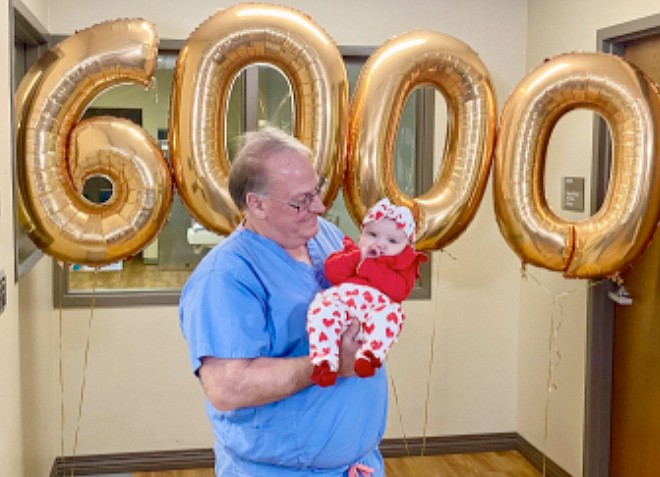Dr. Timothy Cook is pictured with the 6,000th baby he has delivered – Scarlett. Photo Provided.
