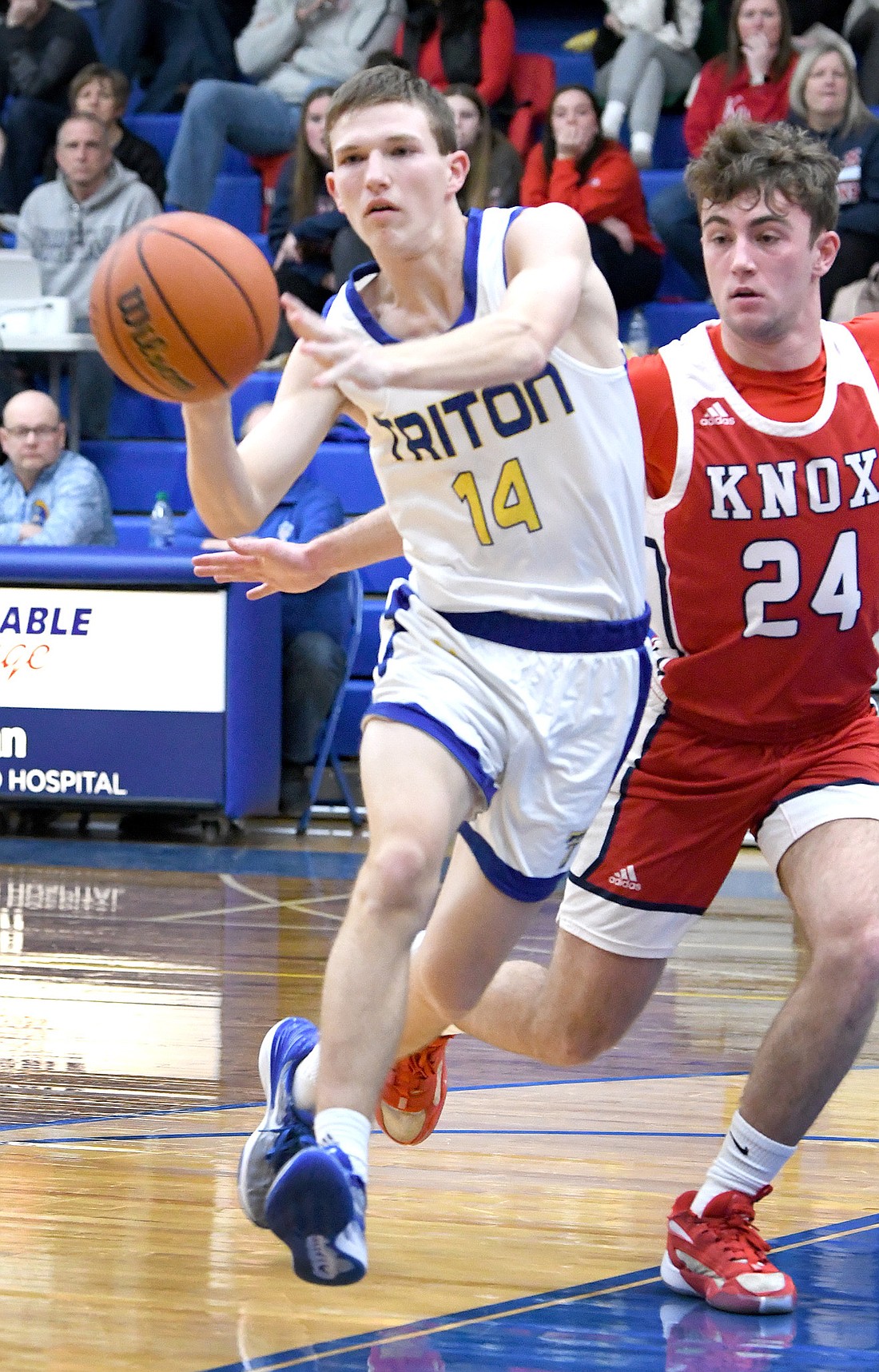 Triton junior Caden Large passes off to a teammate during the first quarter of Friday night's home game against Knox. Photo by Gary Nieter