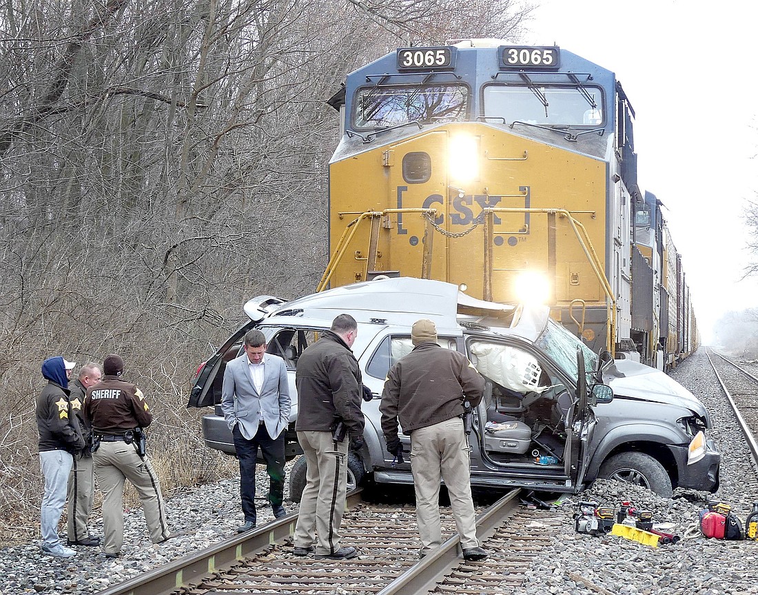 Officers of the Kosciusko County Sheriff’s Office and County Coroner Tyler Huffer investigate the scene of Wednesday afternoon's fatal accident northeast of Syracuse. Photo by Gary Nieter, Times-Union.