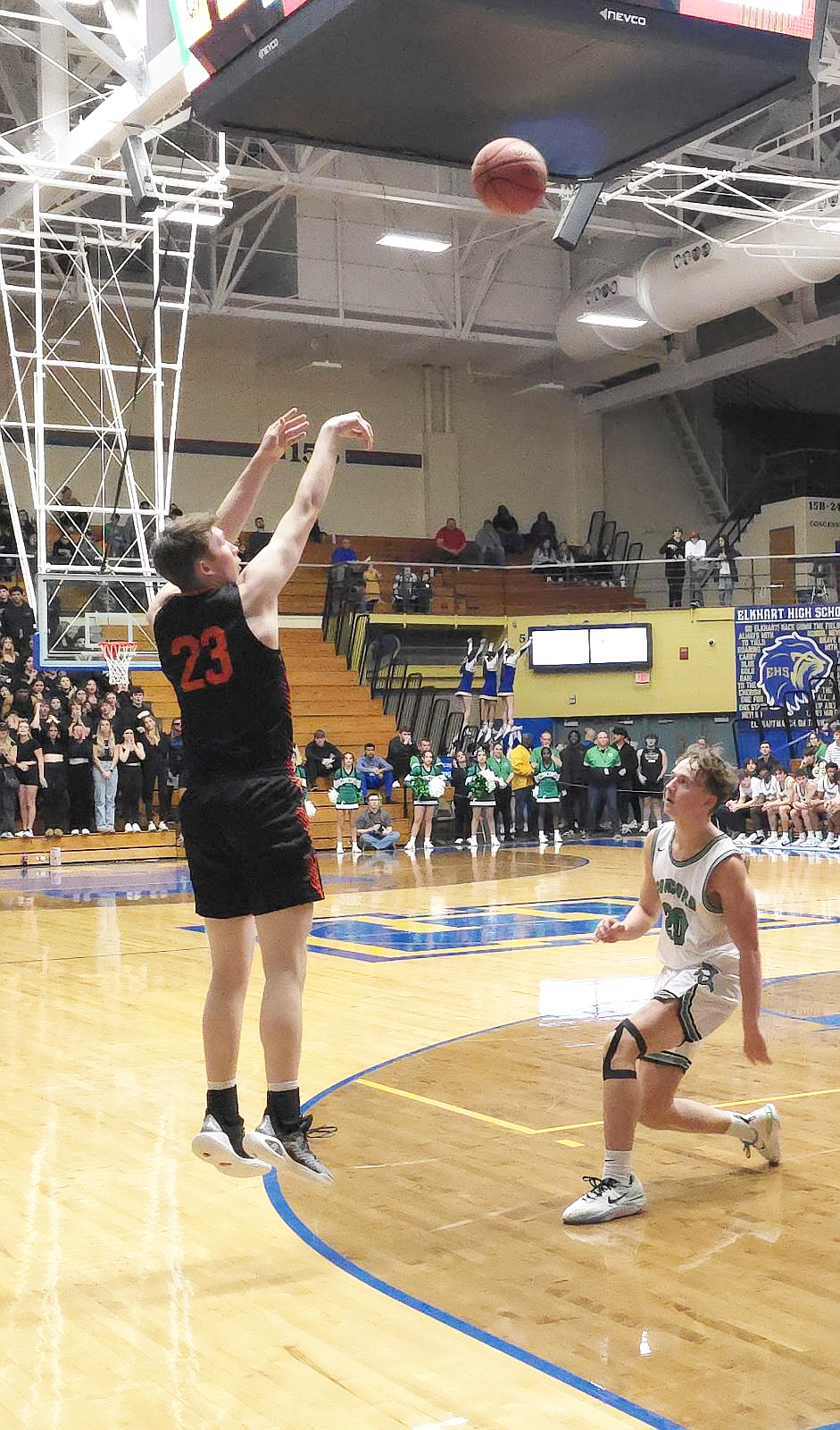 Warsaw junior Brandt Martin launches a three pointer over a Concord defender in Warsaw’s 48-35 win over Concord Friday night. Photo by Stephanie Wilmore