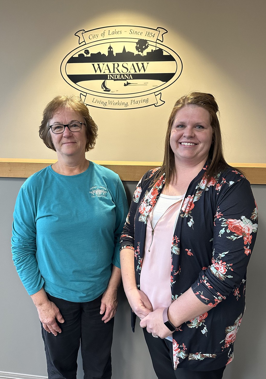 With Shirley Fetrow (L) retiring from the Warsaw-Wayne Fire Territory at the end of the month after 22 years as the chief’s assistant and the recording secretary for the territory board, Heather Vogts (R) was named as her replacement. Photo by David Slone, Times-Union