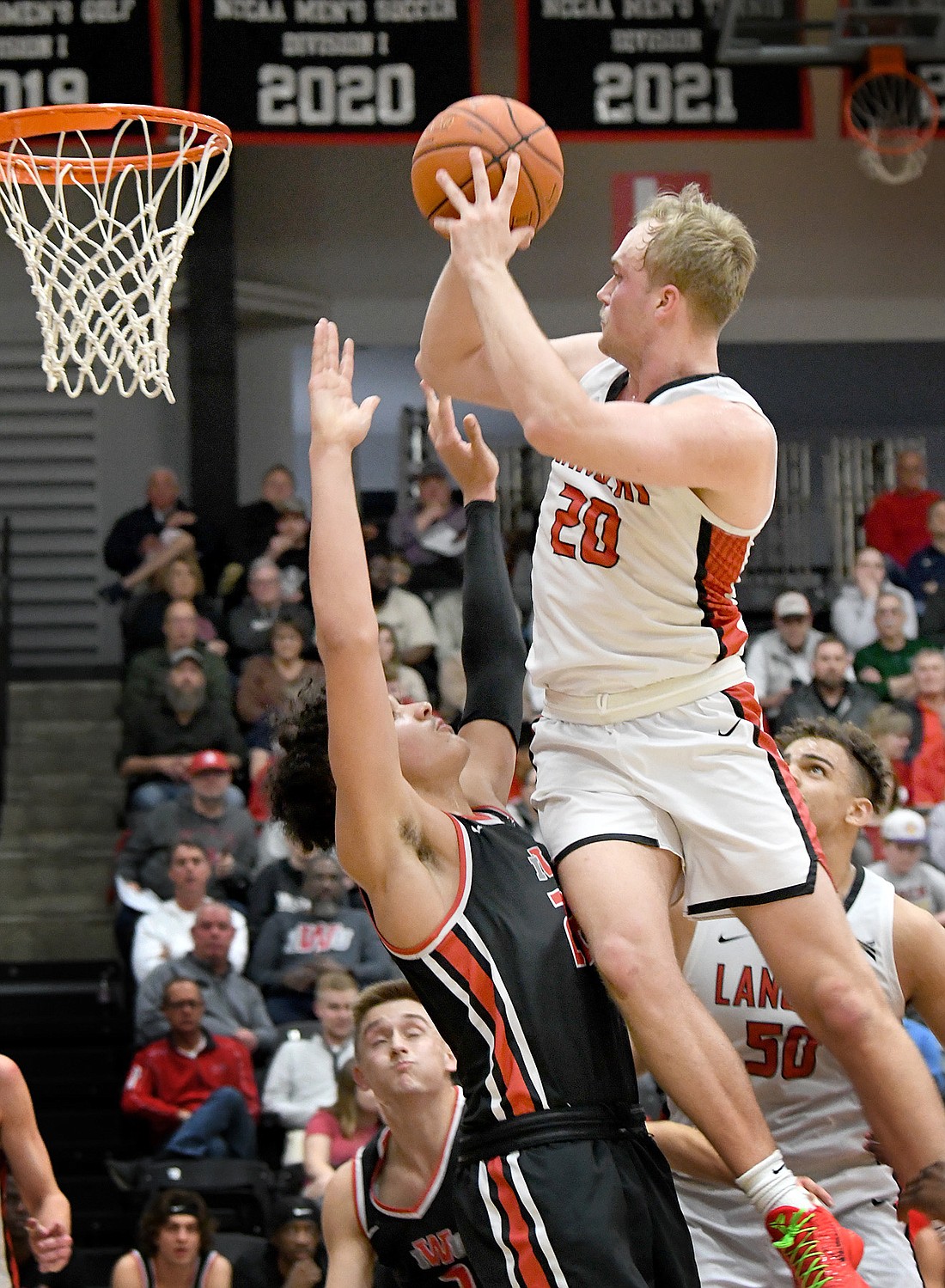 Grace senior Jake Wadding draws a foul while going up for a shot during the first half. Photo by Gary Nieter