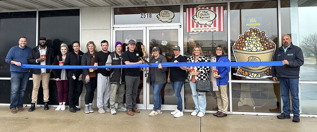 Kosciusko Chamber of Commerce had a ribbon-cutting ceremony Friday for The Dutch Kernal, 2518 Walton Blvd., Warsaw. Cutting the ribbon with the large scissors are Steve (L) and Veronica Miller (R), surrounded by Dutch Kernal staff, Chamber staff and Chamber ambassadors. Photo by David Slone, Times-Union