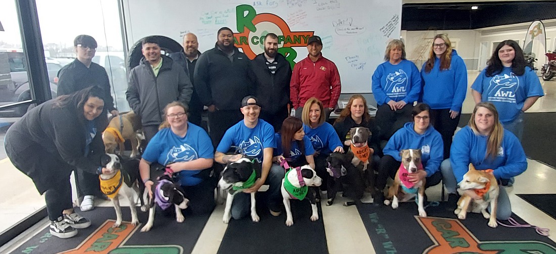 Animal Welfare League of Kosciusko County staff and volunteers and R&B Car Company staff pose with dogs that were available for adoption during the adoption event Saturday at R&B Car Company. Photo by Jackie Gorski, Times-Union