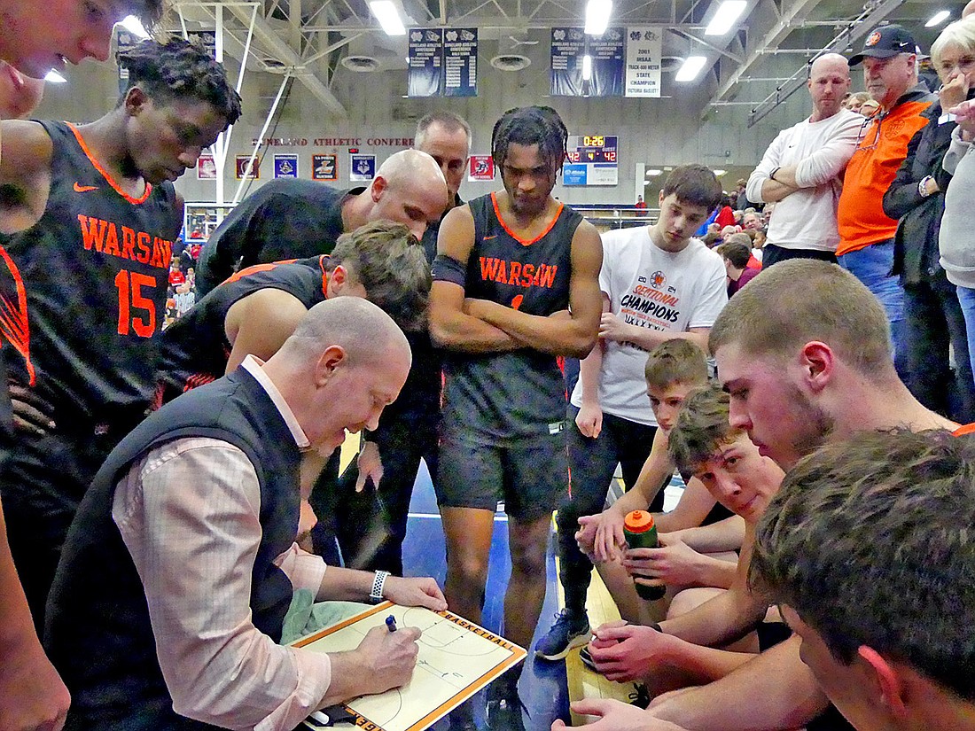 Warsaw head coach Matt Moore draws up a play for his team as the end of regulation play nears. Photo by Gary Nieter