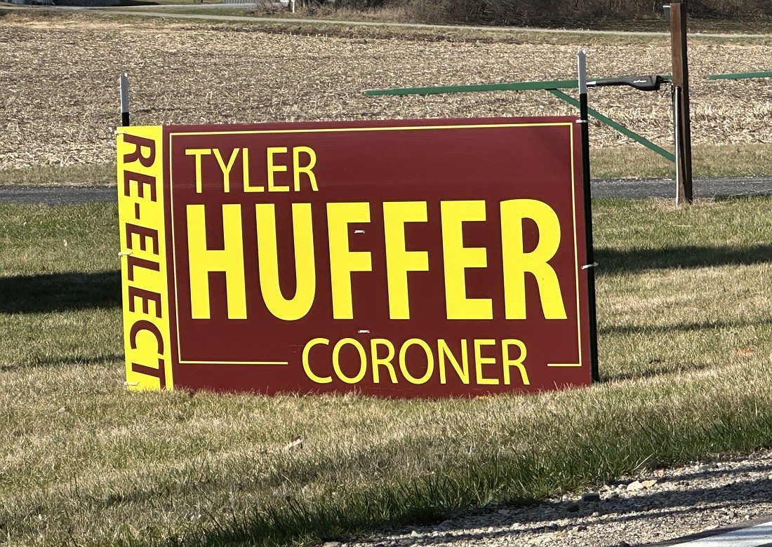 A sign asking voters to “re-elect” Tyler Huffer as county coroner is displayed on Old 30 in Warsaw. Photo by David Slone, Times-Union